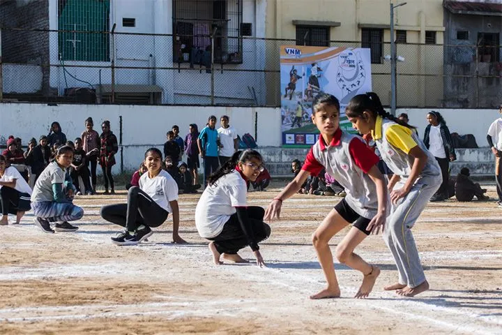 Girls preparing to play kho-kho during inter-school sports event